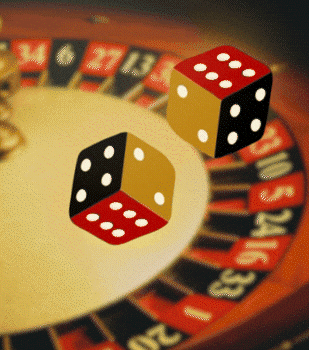 A couple of men standing in front of a laptop computer.